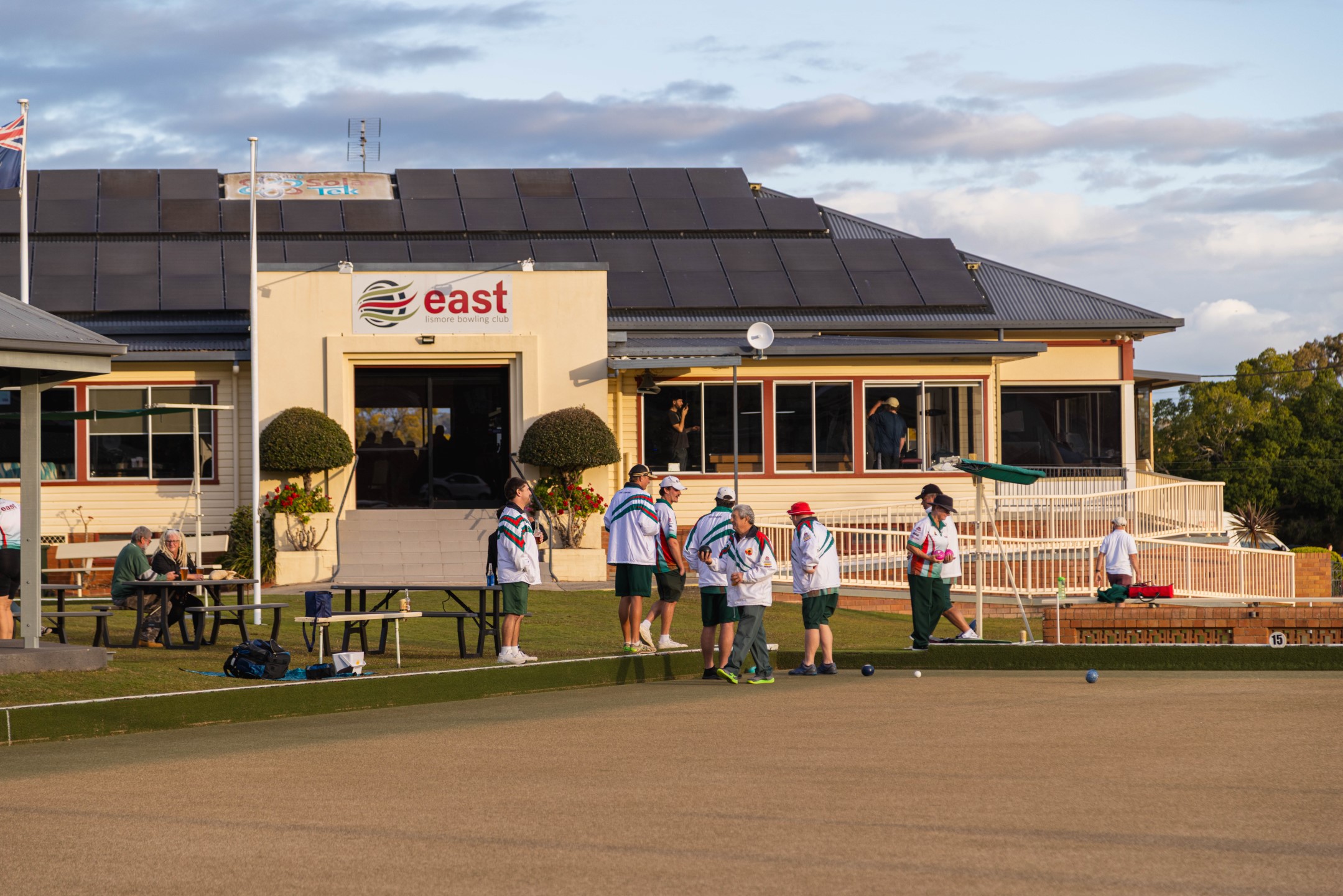 Members gathered outside the clubhouse at golden hour